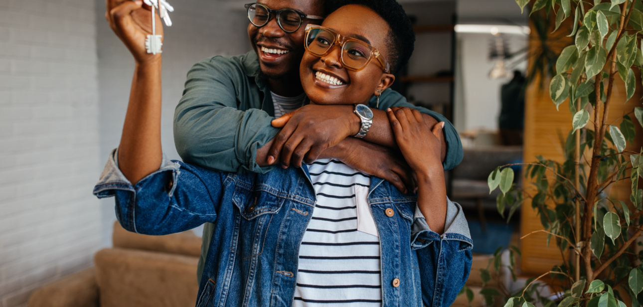 First home buyer in Ghana — couple celebrating with keys to their new starter home